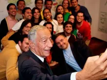 Portugal's President Marcelo Rebelo de Sousa takes a selfie with volunteers from WYD Lisbon 2023.