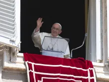 Pope Francis waves from a window of the Apostolic Palace during his Angelus address and prayer on Aug. 20, 2023.