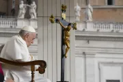 Pope Francis prays in front of a crucifix during his general audience on Oct. 26, 2022.