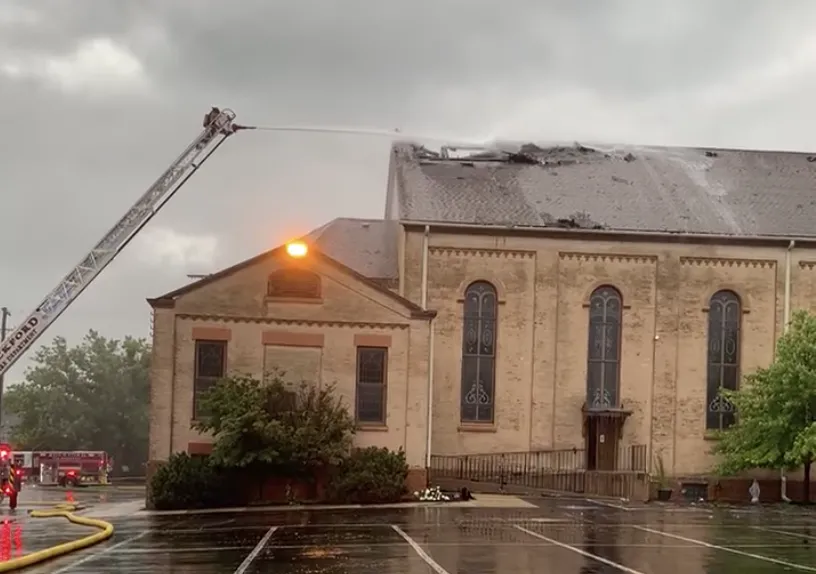 Firefighters work to put out a roof fire at historic St. James Catholic Church, in Rockford, Illinois, on Aug. 8, 2022. The Diocese of Rockford said a lightning strike was a possible cause.?w=200&h=150