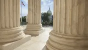 U.S. Capitol viewed through the columns of the U.S. Supreme Court in Washington, D.C.