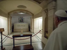 Pope Francis prays at the tomb of Pope Pius XII on Nov. 2, 2021.