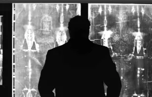 Filmmaker Robert Orlando, standing before a negative image of the Shroud of Turin, says he was prompted to investigate the purported burial cloth of Jesus in part because of a search to answer "big questions" about life and faith following the death of his father. Courtesy of Nexus Media