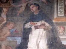 The lunette of a side door depicting St. Thomas Aquinas, detail of the facade of the Church of Santa Maria Novella in Florence, Italy.