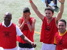 Young people in sports jerseys react after winning a friendly soccer game at World Youth Day in Panama in 2019.