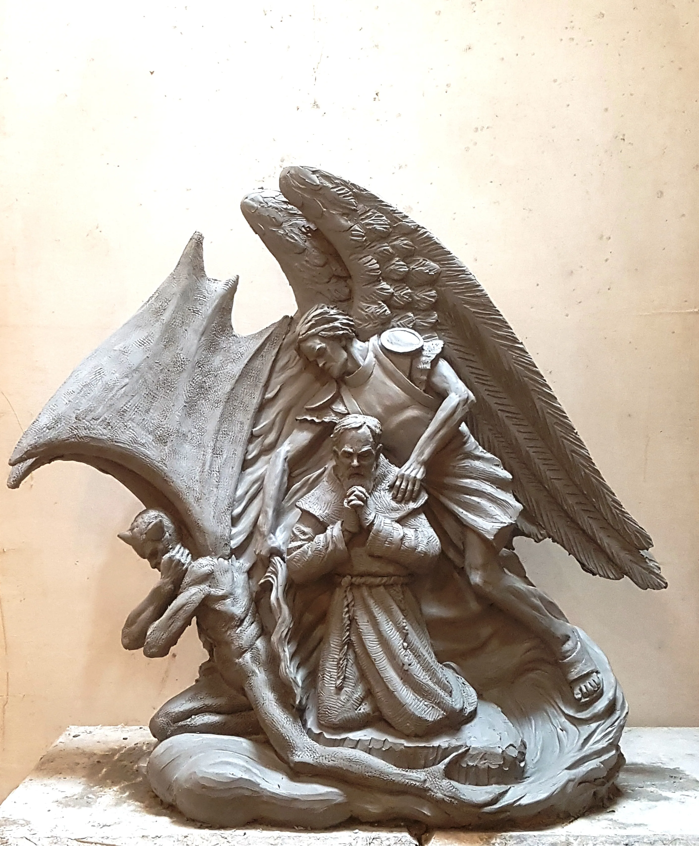 Artist Timothy P. Schmalz's sculpture depicts St. Michael the Archangel protecting Padre Pio, as he kneels in prayer, from a demon. Courtesy of Timothy P. Schmalz