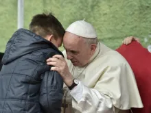 Pope Francis listens to a boy called Emanuele at St. Paul of the Cross parish, Rome, on April 15, 2018.