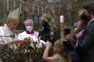 Pope Francis baptizes a child in the Sistine Chapel on Jan. 9, 2021