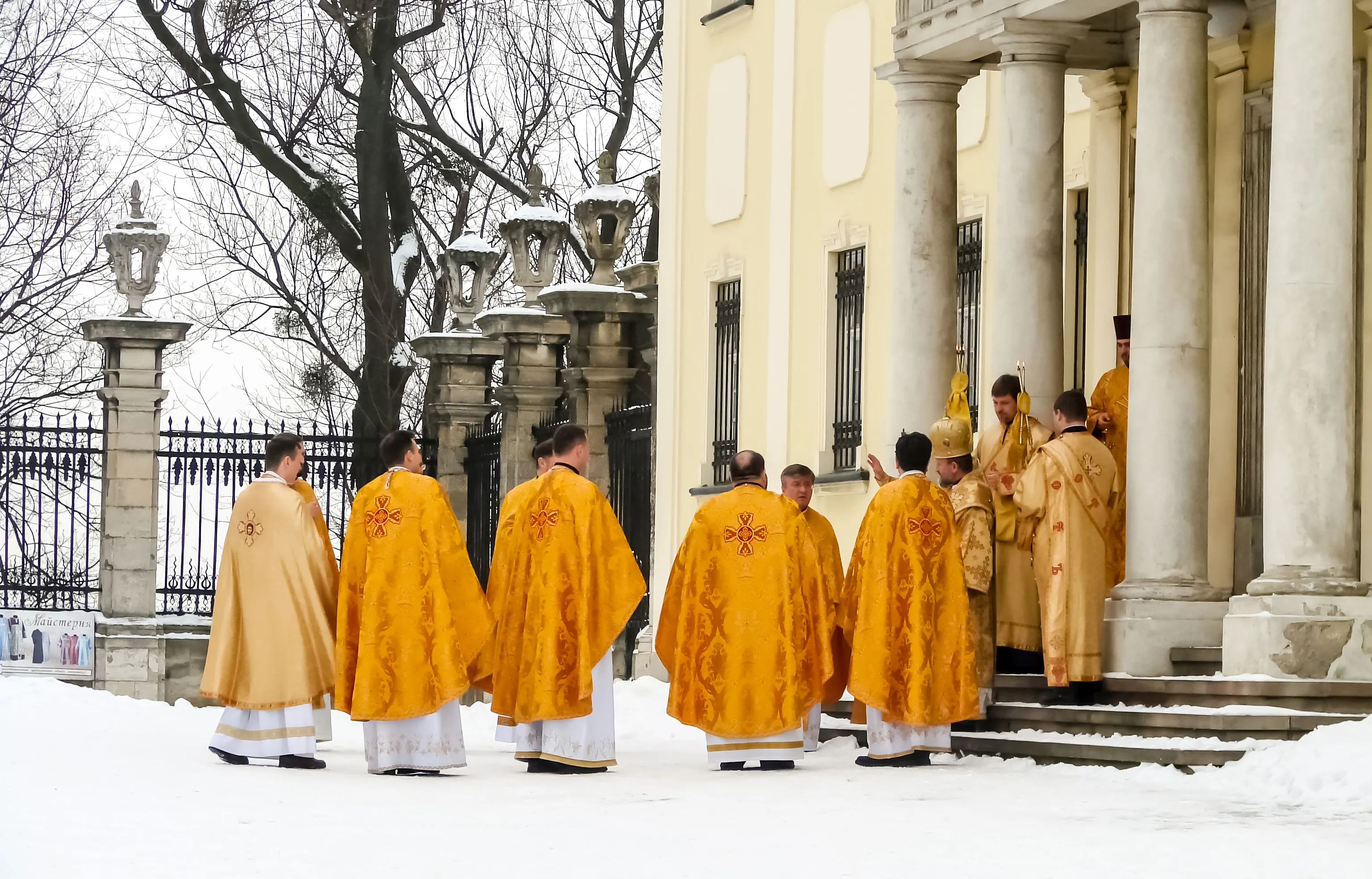 Greek-Catholic priests in traditional bright cassocks in front of a church in Lviv, Ukraine, in 2018. Shutterstock