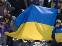 People raise the Ukrainian flag at Pope Francis' Angelus adrdess at the Vatican, March 6, 2022.
