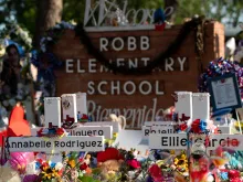 Texans on June 5, 2022, visit the memorial at Robb Elementary School dedicated to the victims of the May shooting in Uvalde, Texas.