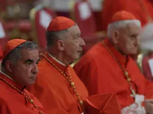Cardinal Angelo Becciu (left) at the consistory in St. Peter's Basilica, Aug. 27, 2022.