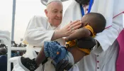 Pope Francis greets a young boy a Mass in Juba, South Sudan on Feb. 5, 2023.